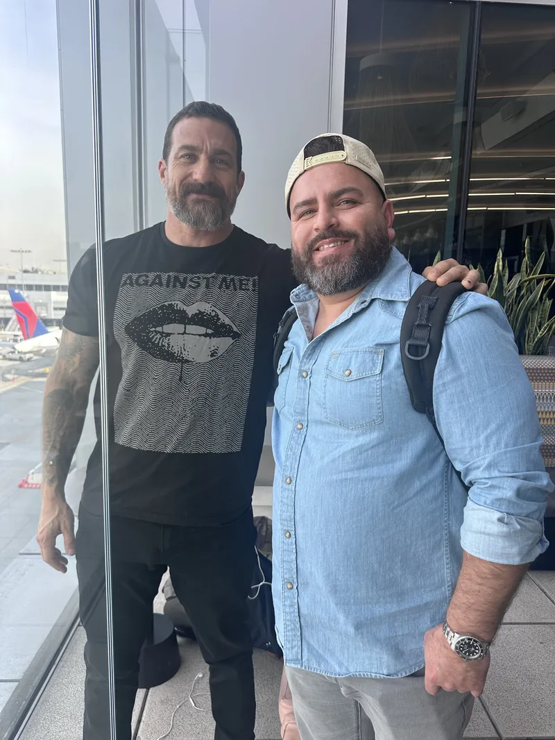 Steven F. Gonzalez standing with Andrew Huberman in the Delta lounge at LAX